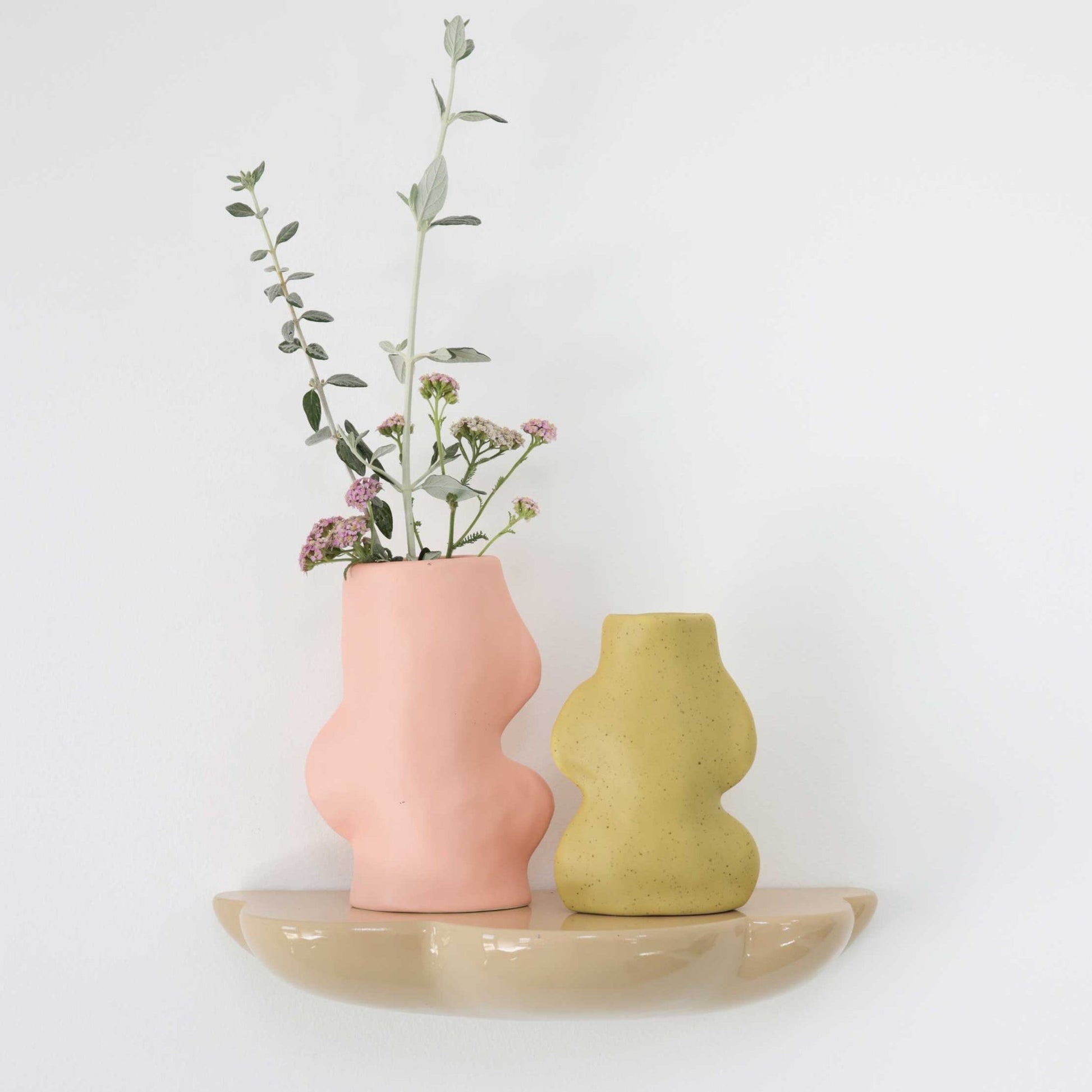 bold pistachio ceramic vase with dramatic lighting highlighting its flowing handmade form