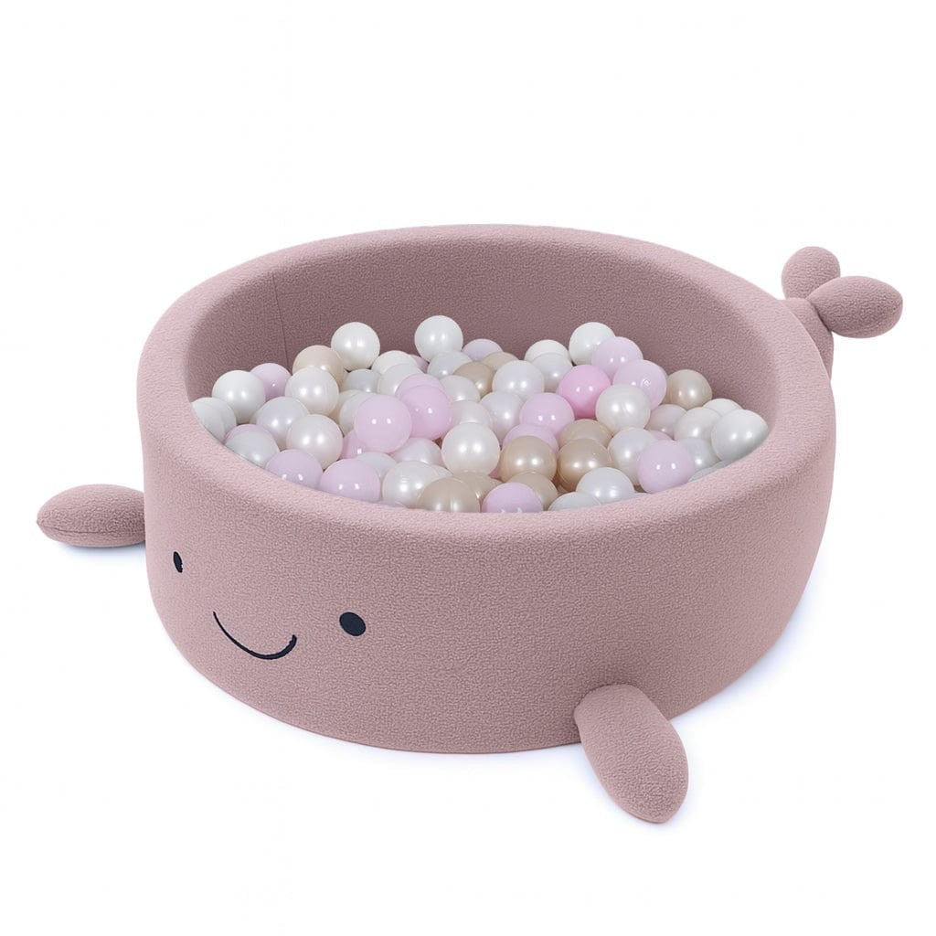 bold raspberry pink whale ball pit with plush boucle texture in a bright nursery