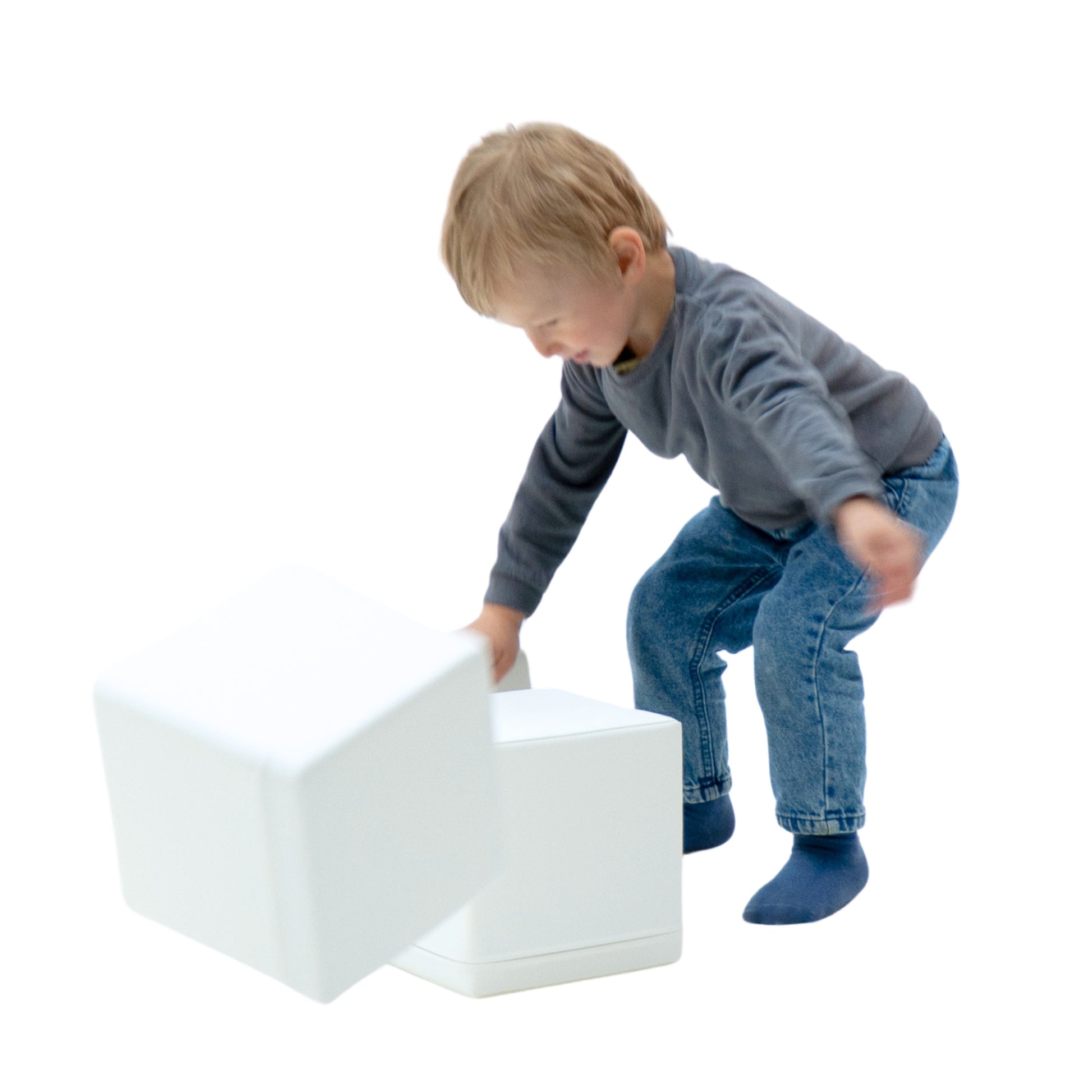 child's hand placing a soft foam block on a colorful igloo structure
