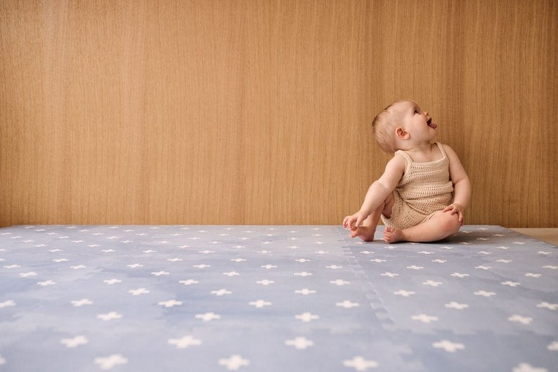 a soft azure foam playmat in a cozy nursery, bathed in gentle morning light