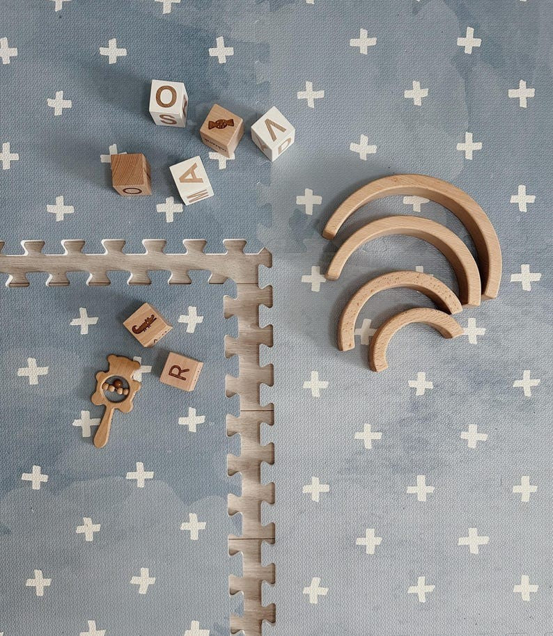 a close-up view of the stylish cross azure foam puzzle playmat pieces interlocking on a clean floor