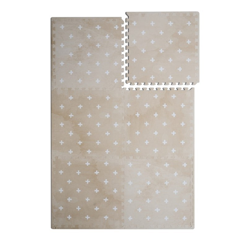 a close-up detail of the cross sand foam mat's elegant neutral texture