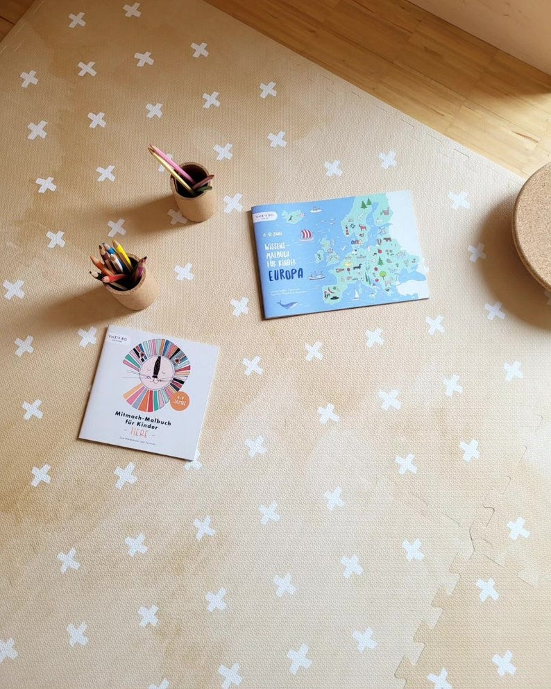 a close-up detail of the foam puzzle playmat's interlocking cross sand design