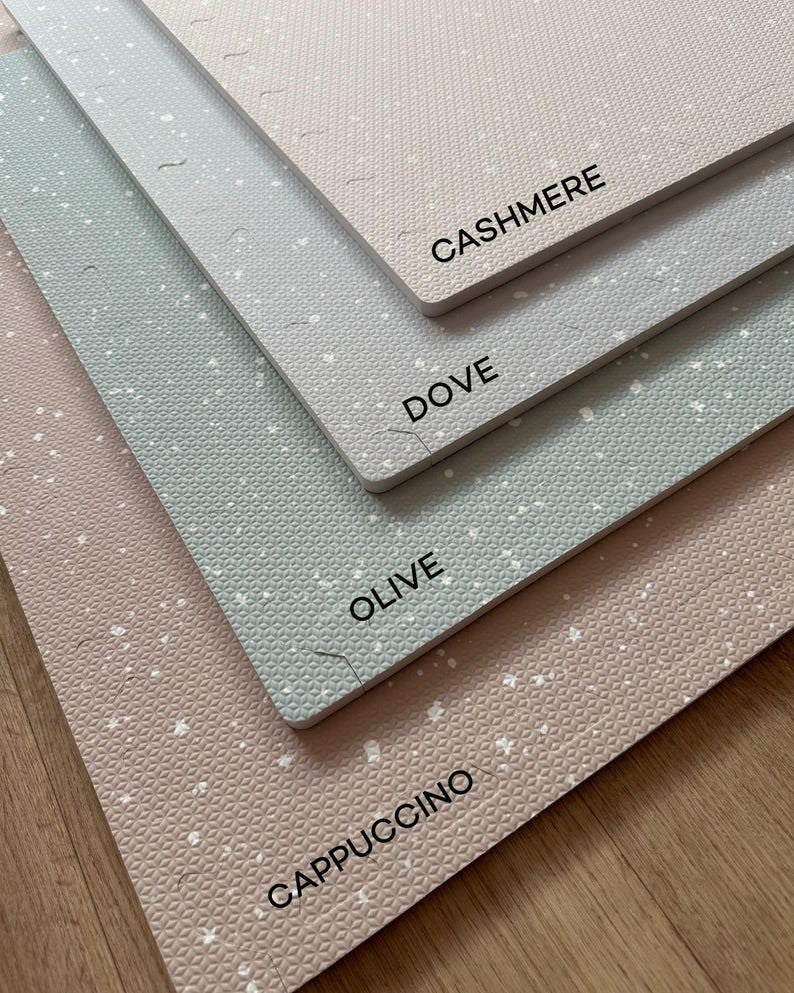 close-up of a soft dove grey baby playmat showing its 1.2 cm thick foam edge and puzzle-piece connection