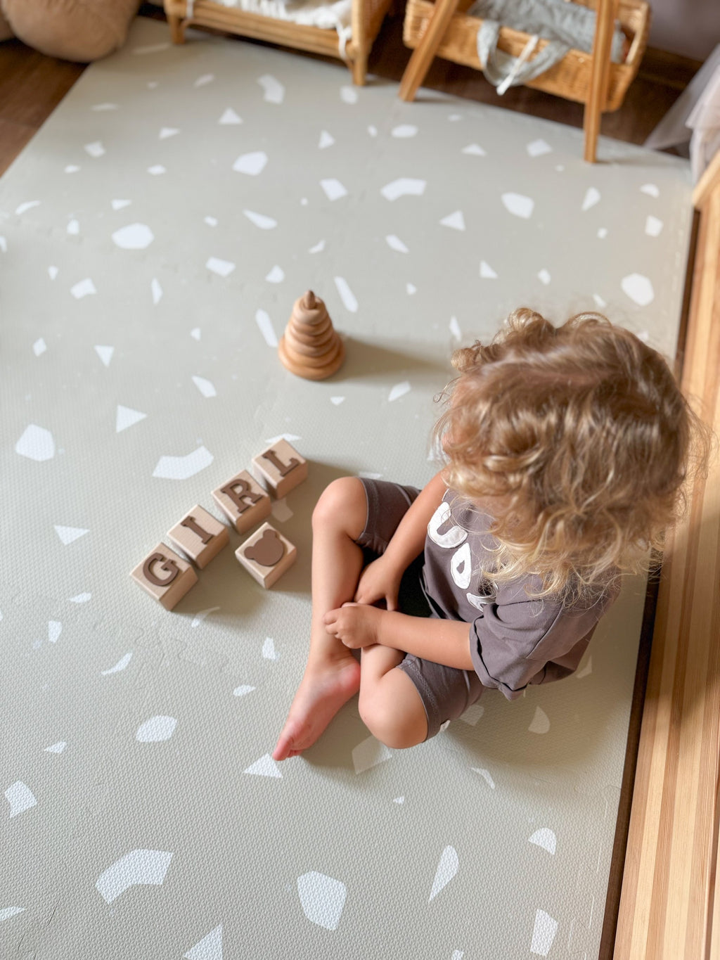 a close-up of the elegant terrazzo dove foam playmat, showcasing its sophisticated neutral pattern and soft texture