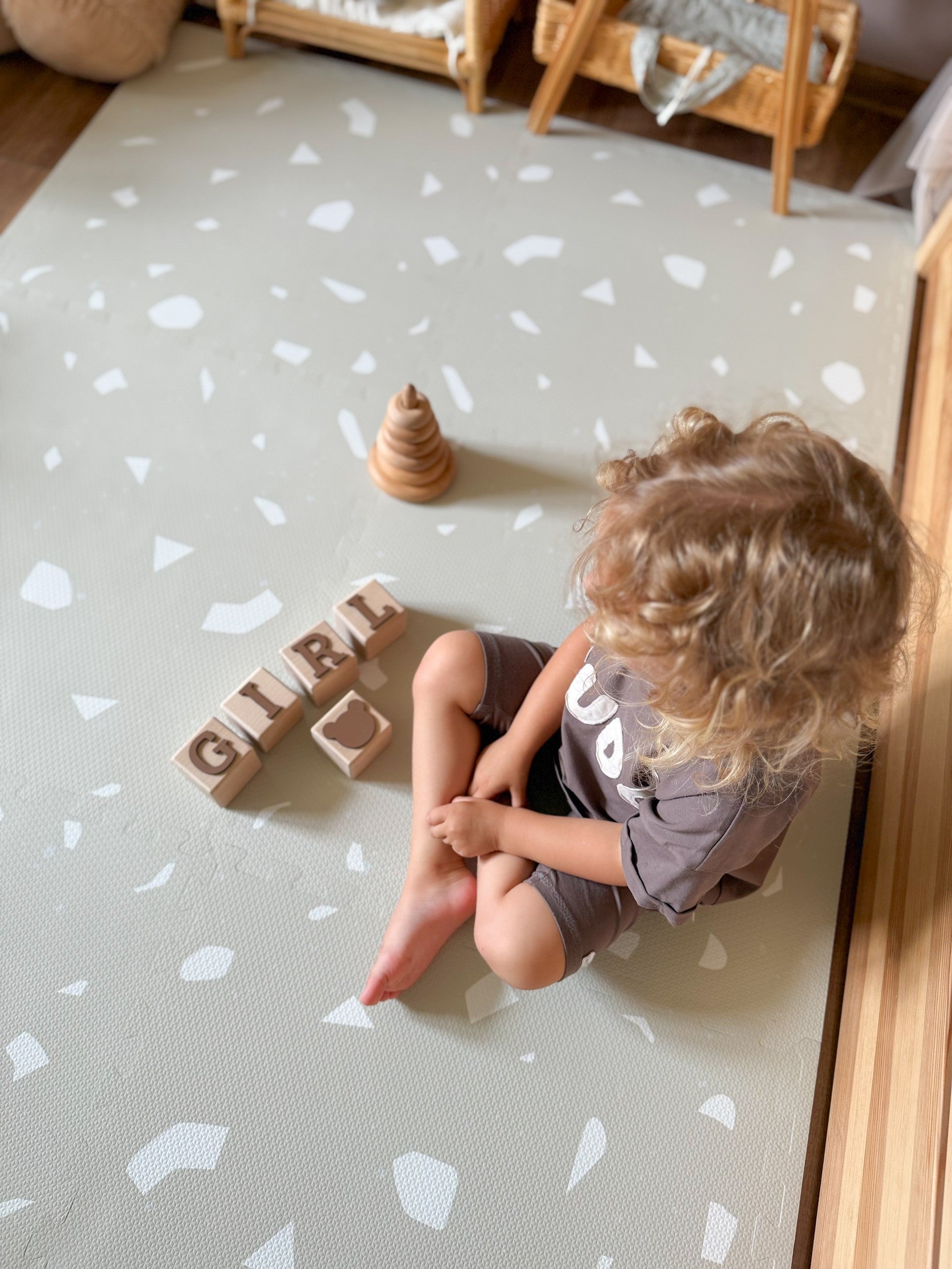 a close-up of the elegant terrazzo dove foam playmat, showcasing its sophisticated neutral pattern and soft texture