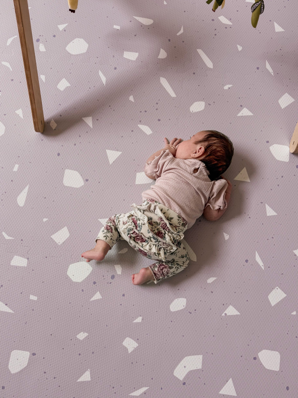 a soft lavender terrazzo foam playmat bathed in gentle morning light
