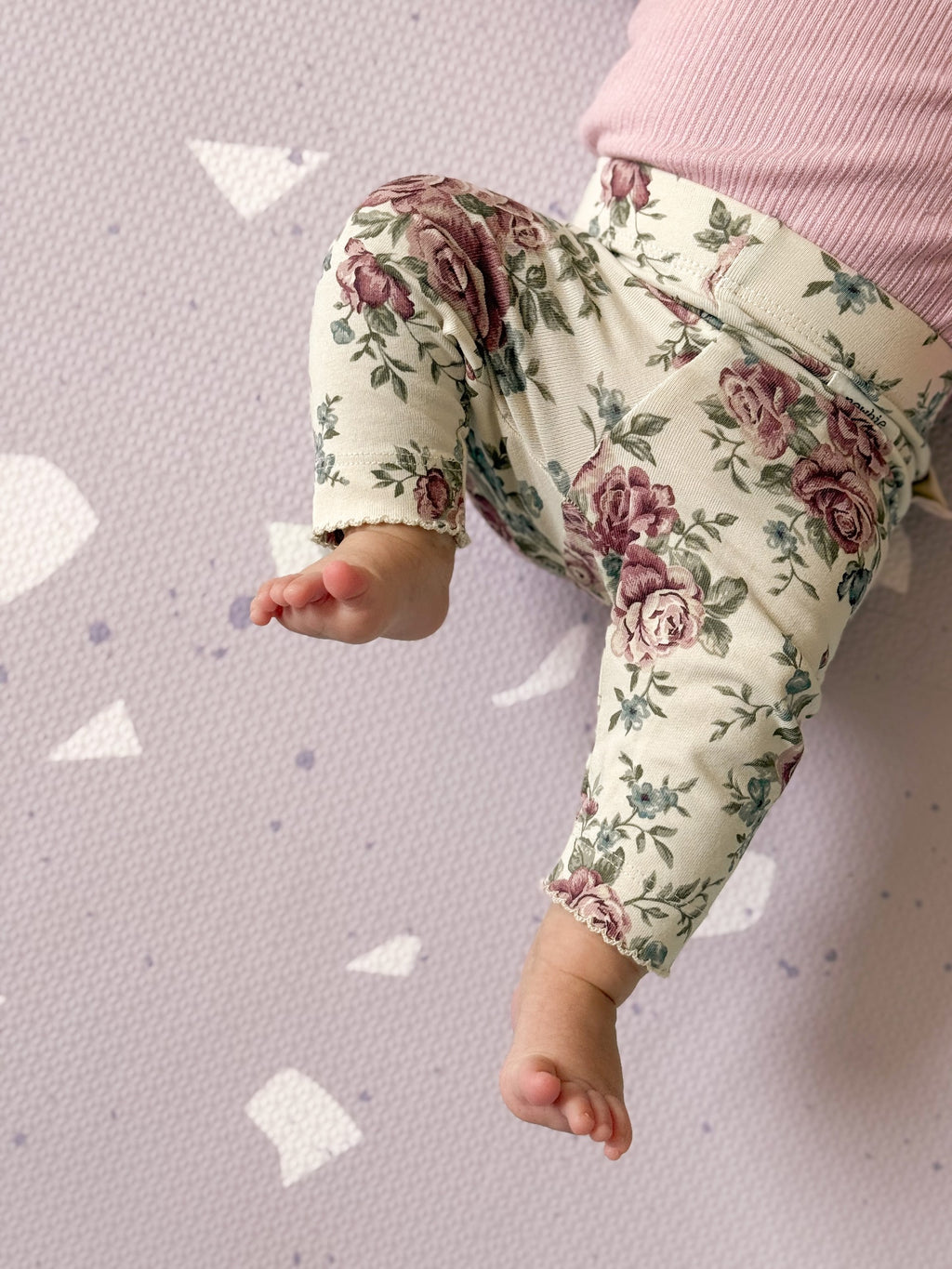 a close-up detail of the lavender terrazzo foam playmat showing its soft texture and chic pattern