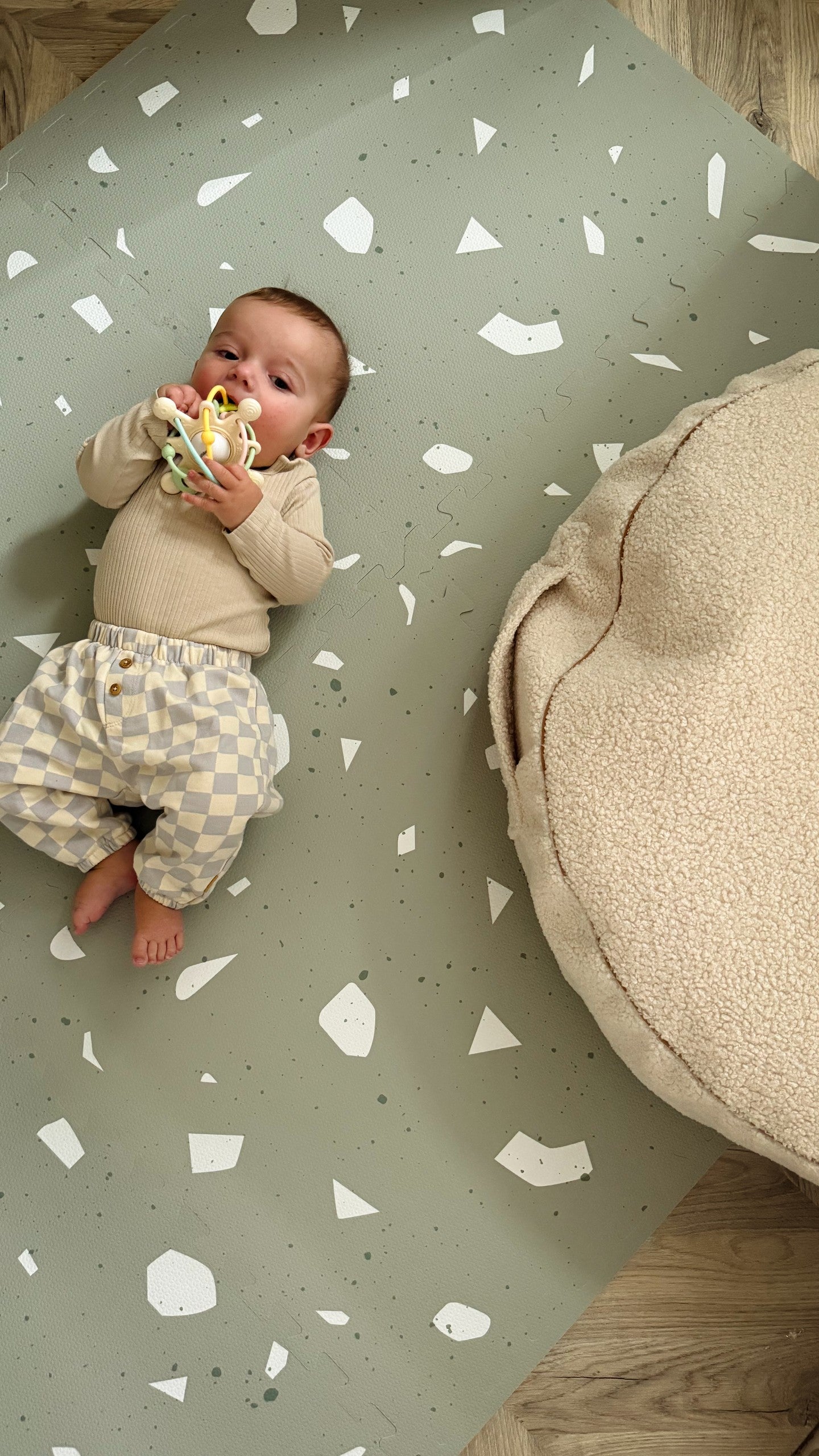 sage terrazzo foam playmat tiles arranged in a sunlit nursery corner