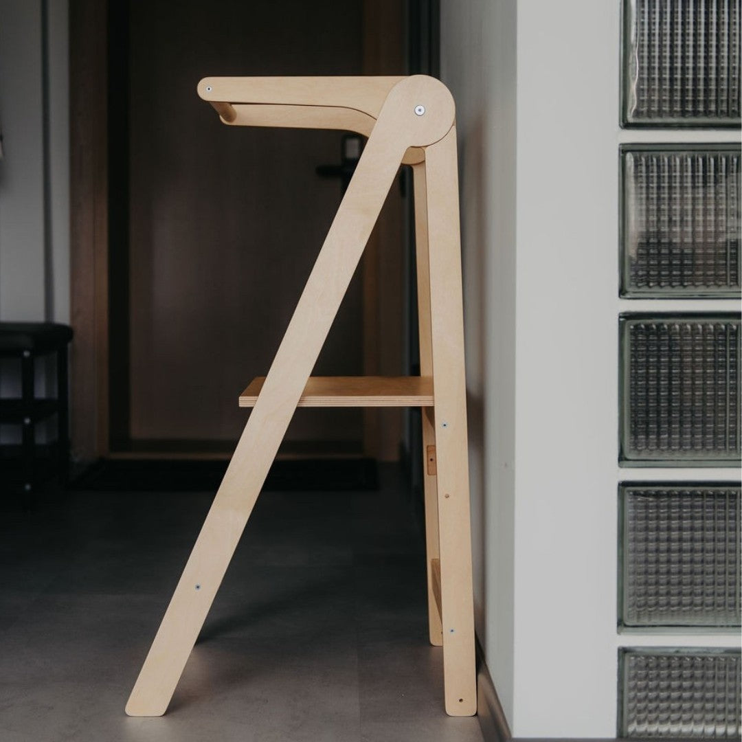 elegant finnish birch kitchen helper tower with safety rail in a refined, minimalist home setting