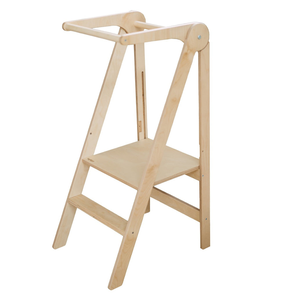 foldable kitchen helper tower in a bright kitchen with morning light on its birch wood
