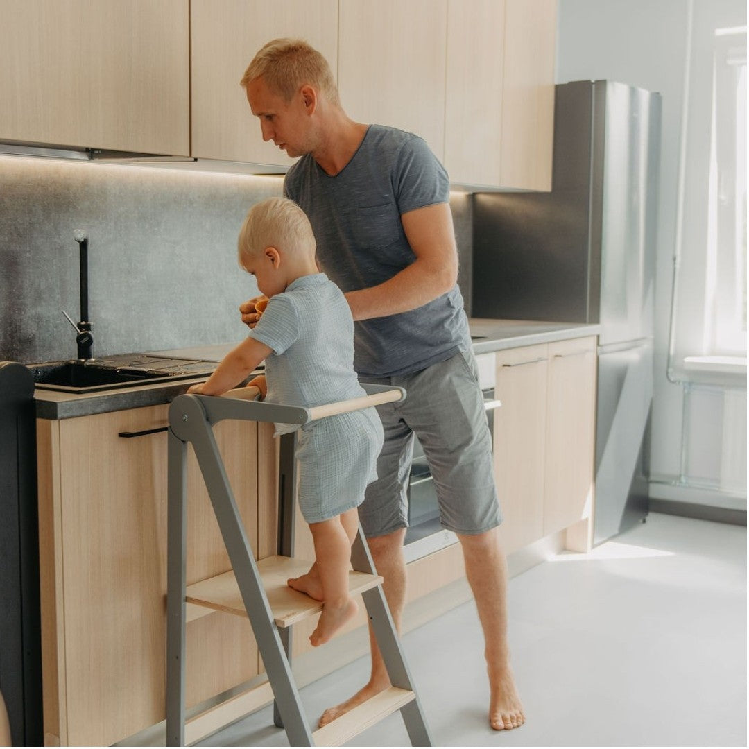bold foldable kitchen helper tower with safety rail in a modern, sunlit kitchen