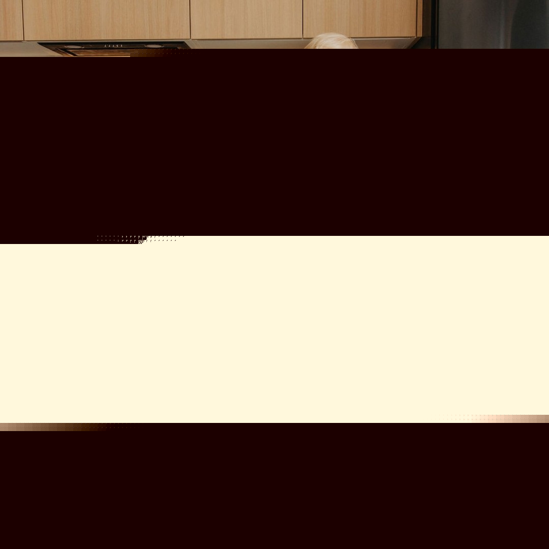 a child's hand on the birch safety rail of a folded kitchen helper tower