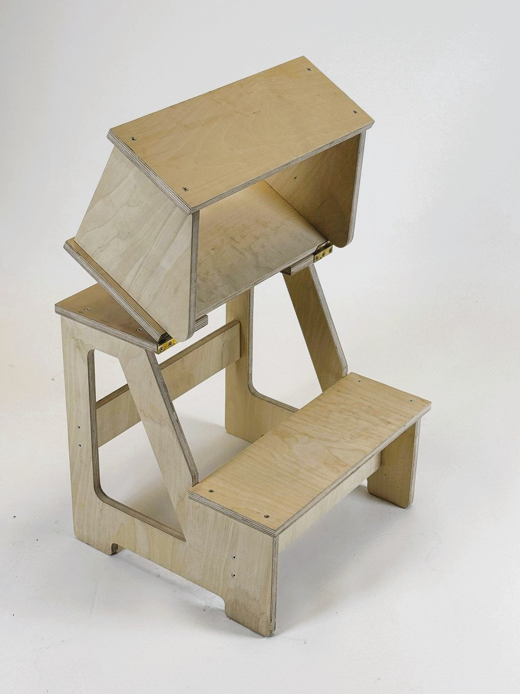 a functional folding wooden step stool in use by a child reaching a high shelf