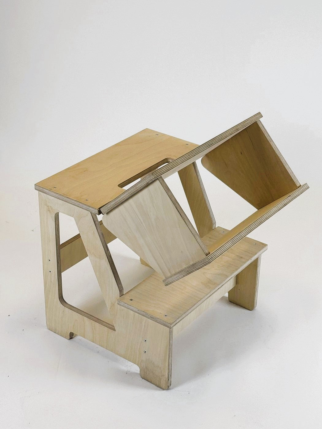 a functional folding step stool and seat in a bright, sunlit playroom setting