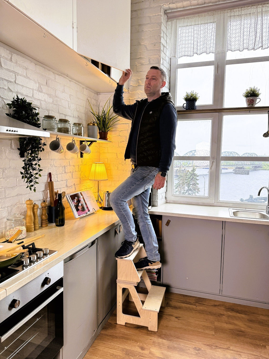a child using the solid wood step stool to reach a bathroom sink
