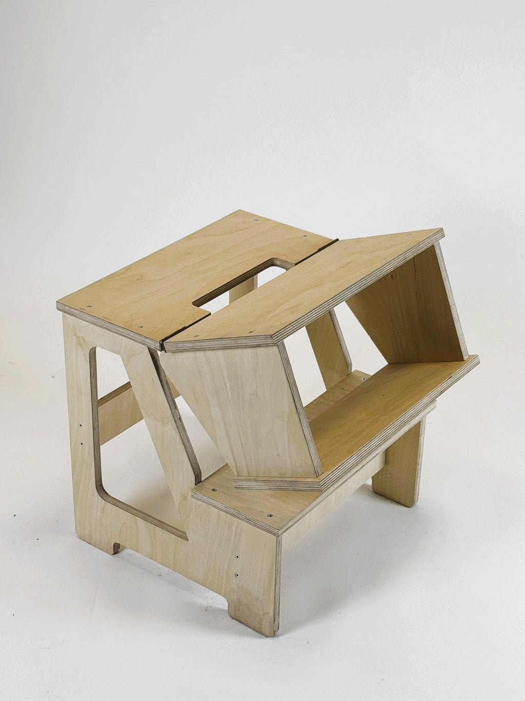 versatile solid wood step stool and seat folded flat in a bright nursery