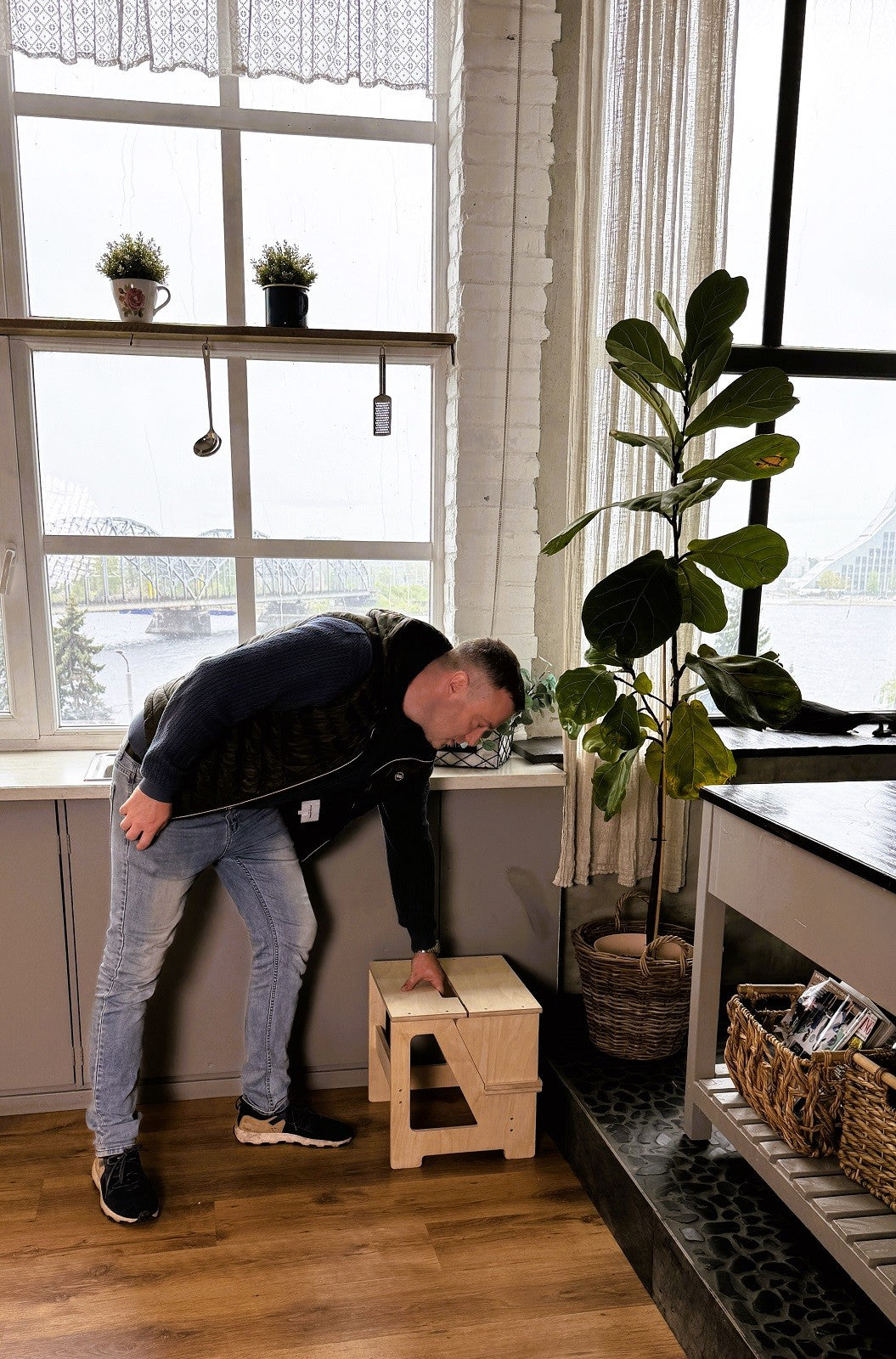 versatile wooden step stool and seat folded compactly in a bright nursery corner