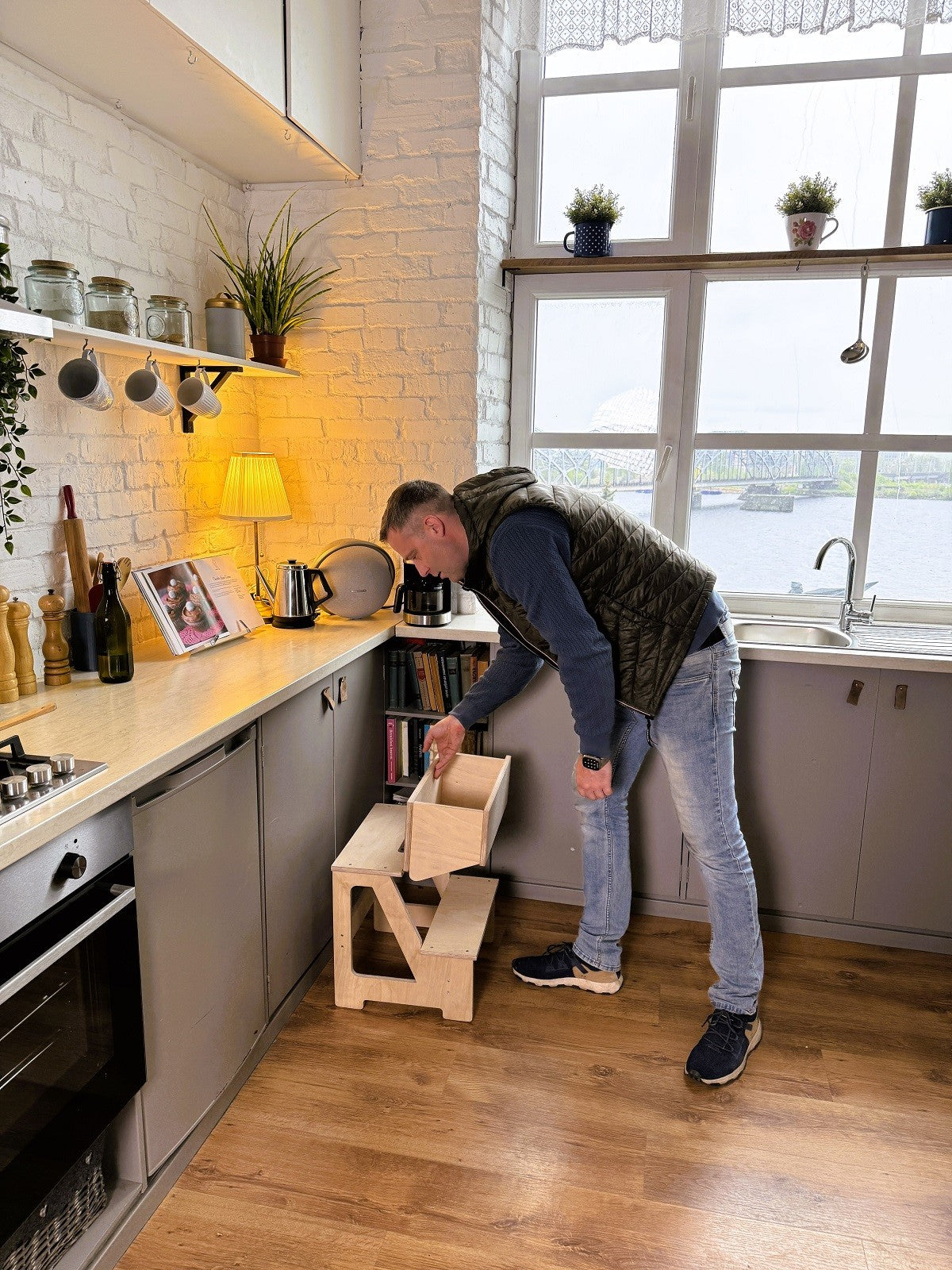 natural wood step stool and folding seat in a bright, sunlit nursery setting