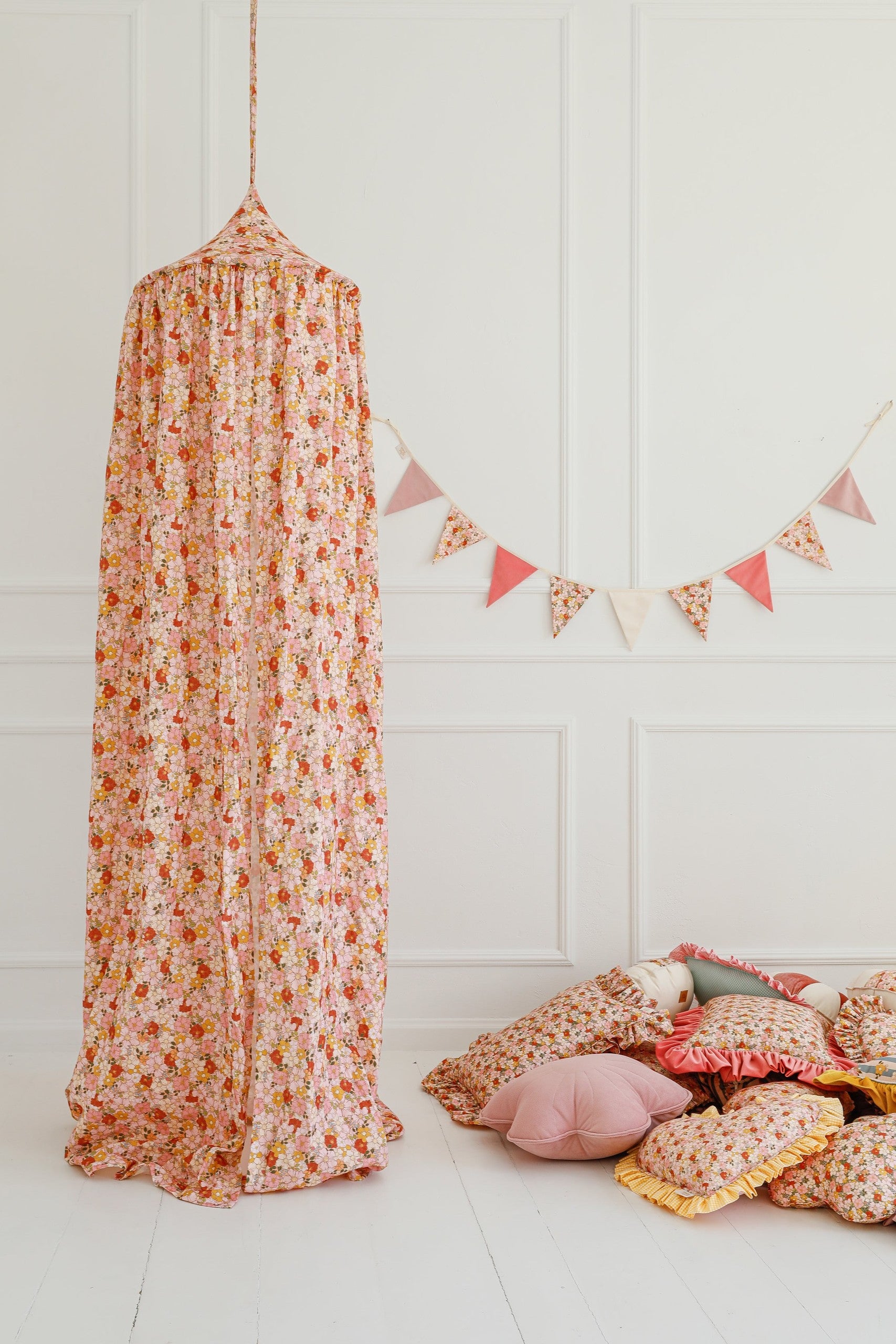 a bold and enchanting cotton and velvet birthday garland hanging over a child's bed