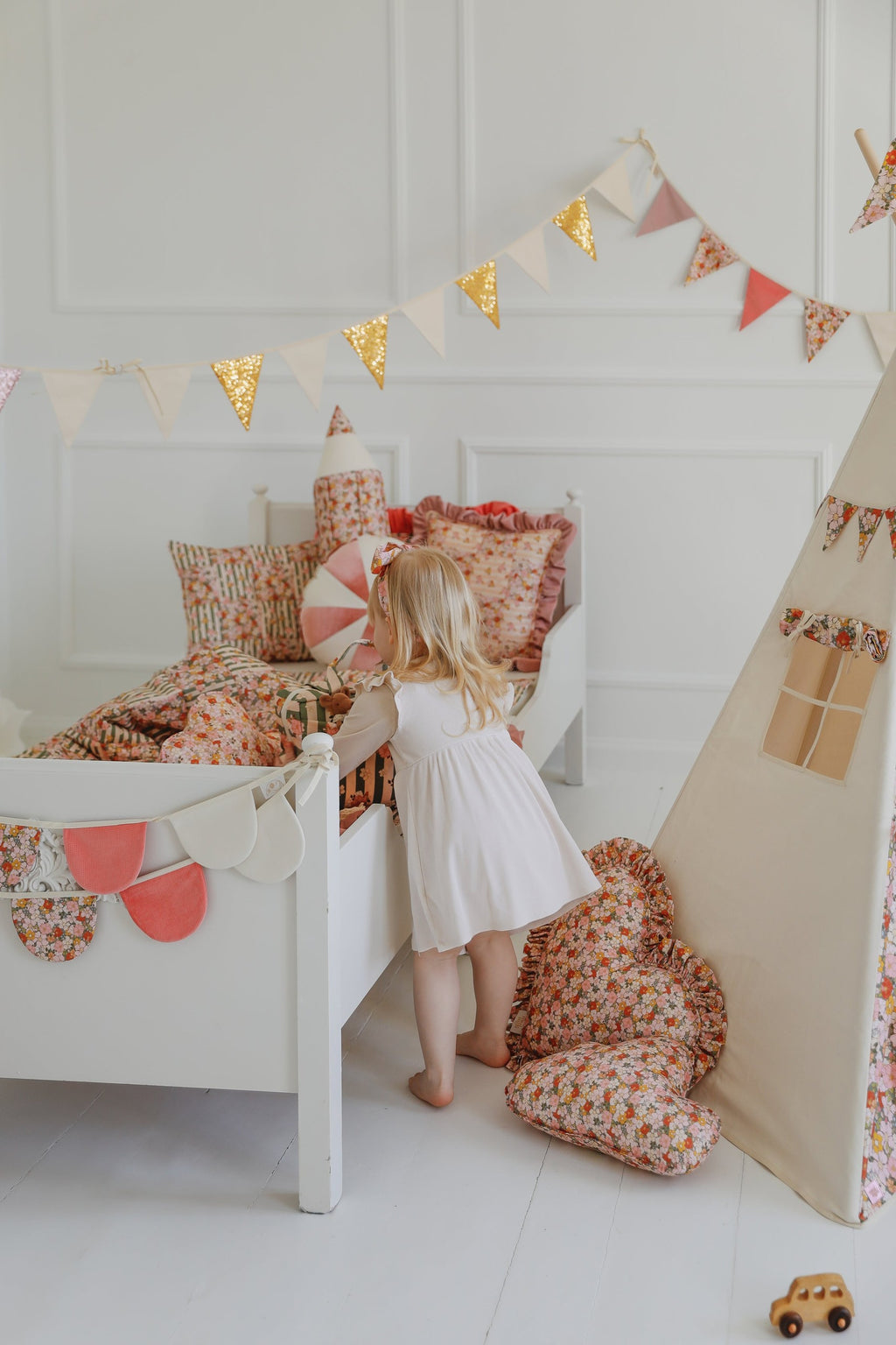 soft cotton and velvet birthday garland draped gently over a cozy child's bed