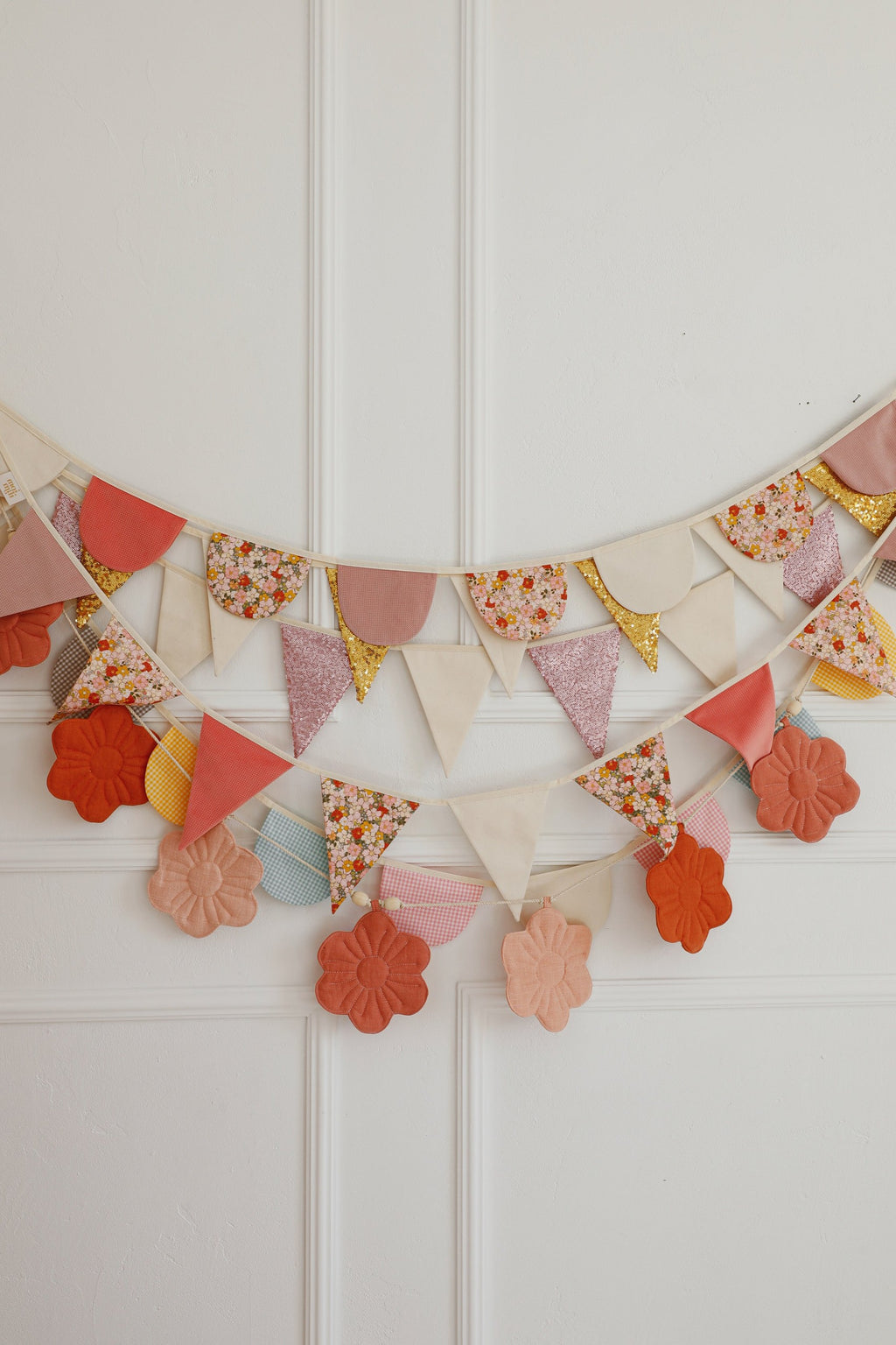 magical cotton and velvet birthday garland hung over a cozy teepee tent