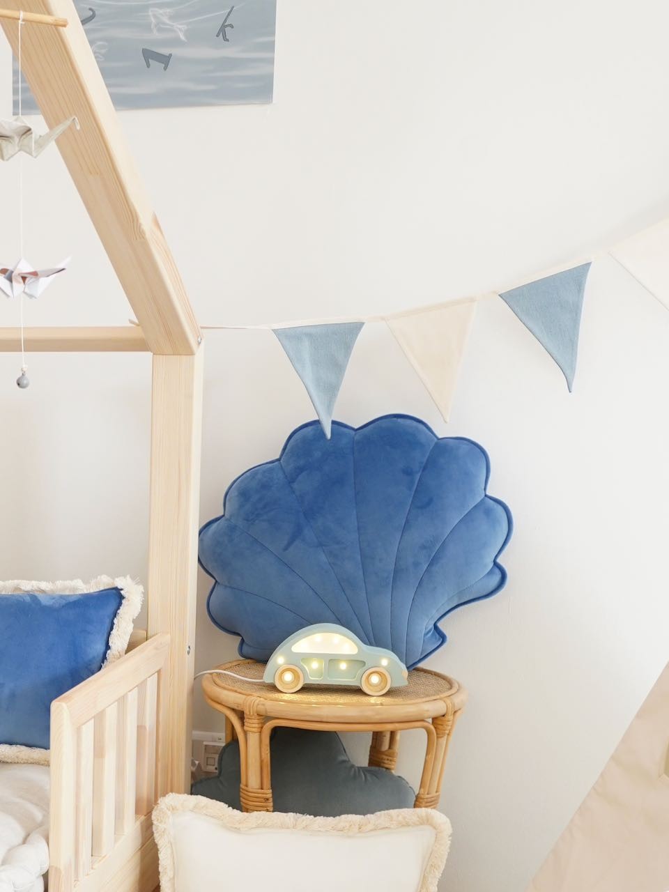 soft cotton and linen jeans garland draped over a wooden crib in warm sunlight