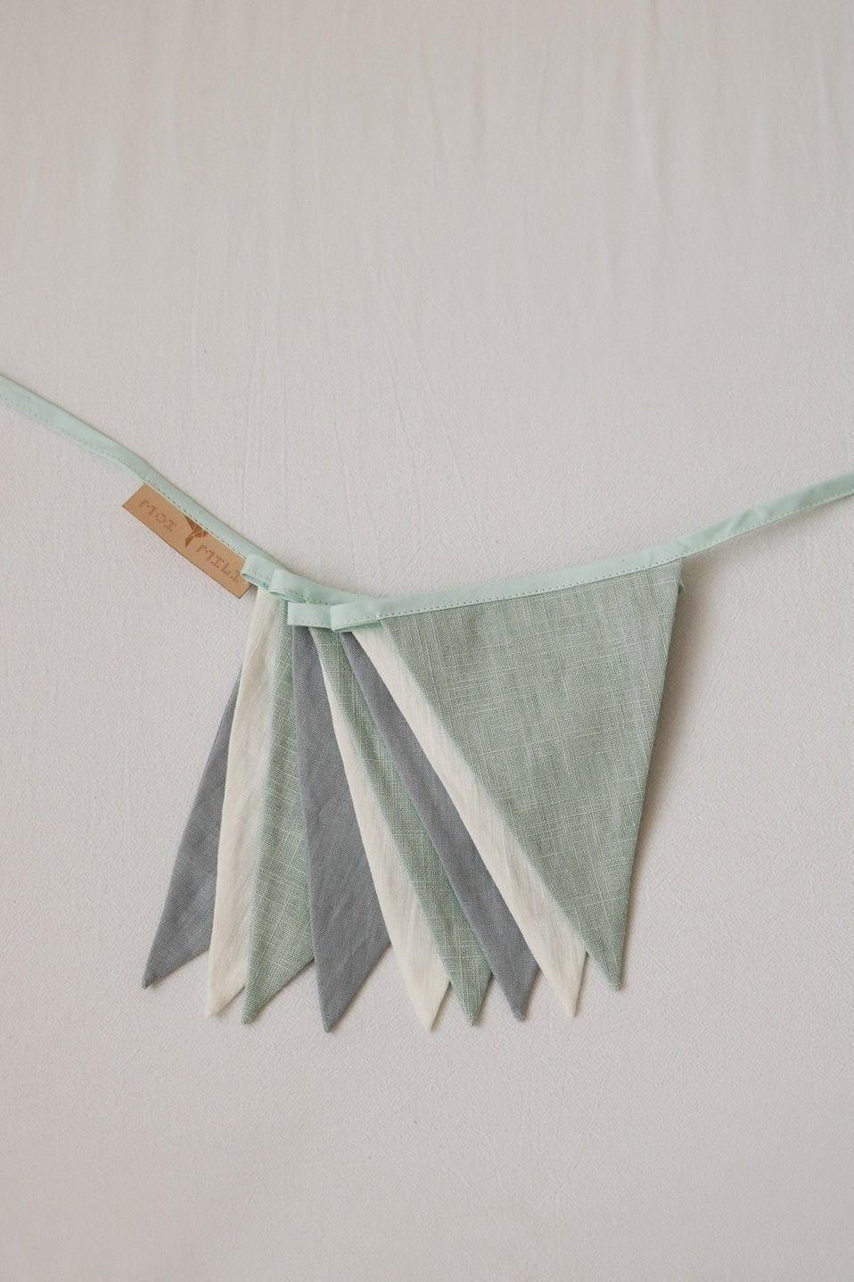 elegant mint love garland with nine linen and cotton pennants, draped gracefully for refined nursery decor