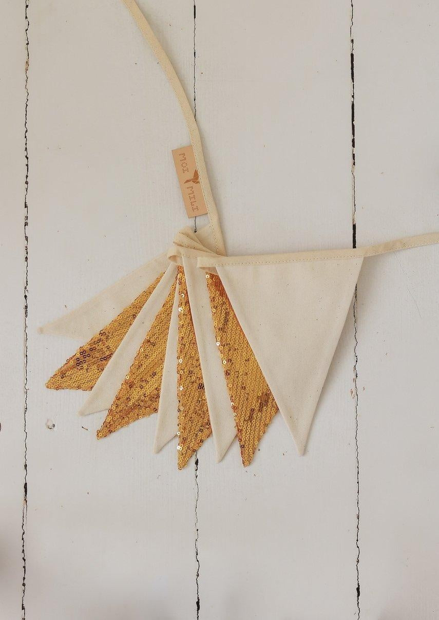 elegant gold and beige sequin garland draped gracefully over a canopy, catching the light