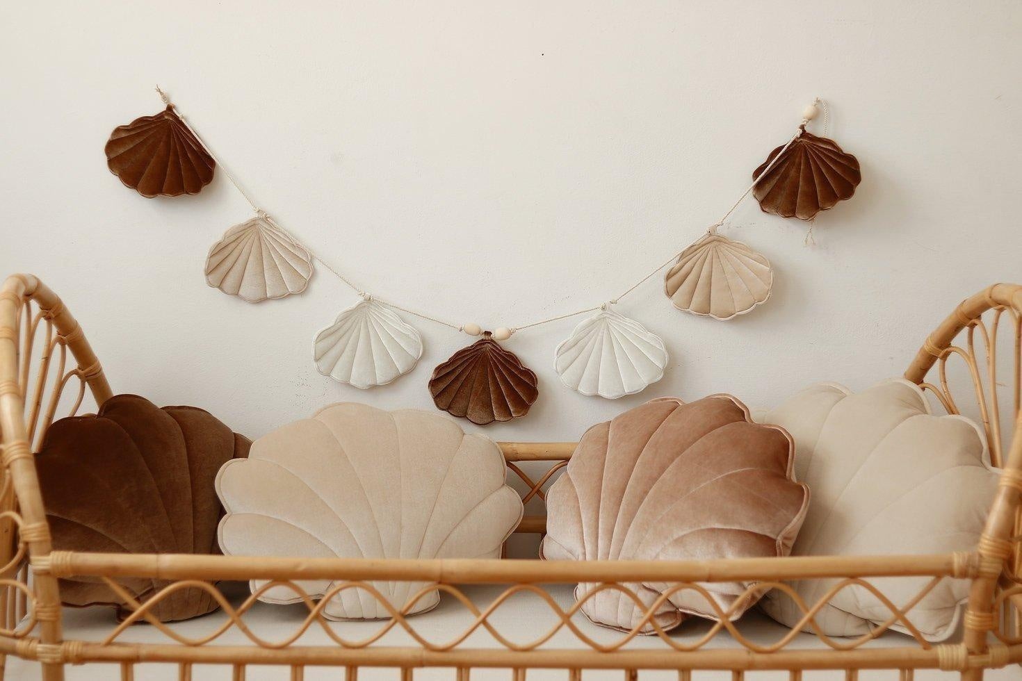 soft beige pearl and velvet shell garland with wooden beads draped over a cozy reading nook