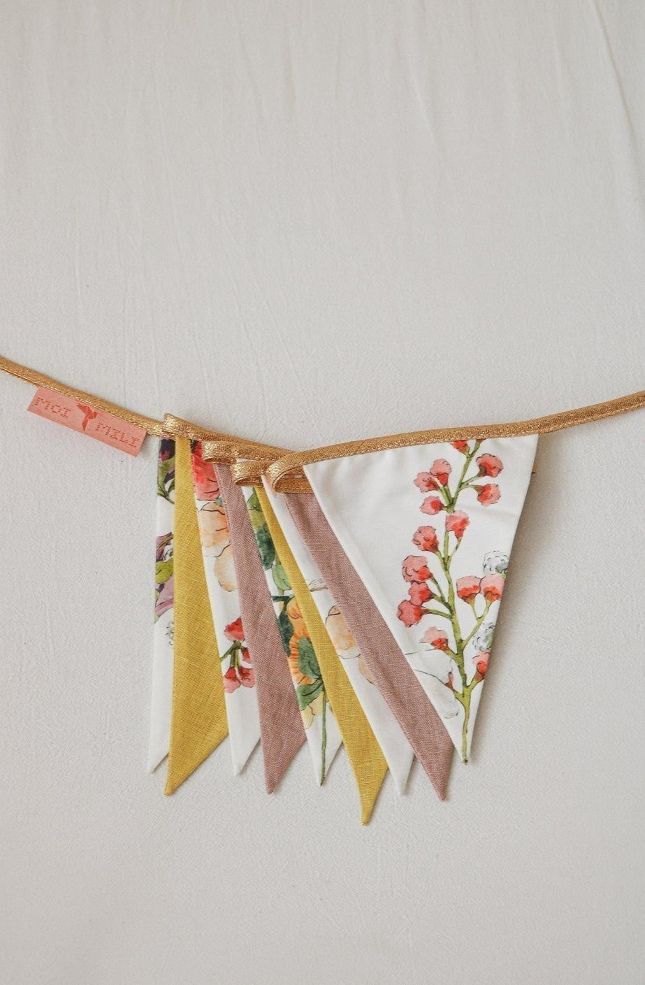 playful wildflower garland draped over a teepee in a sunlit kids room