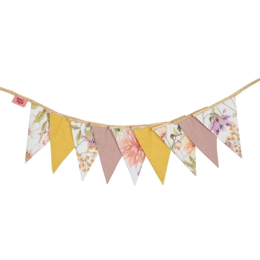 soft cotton and linen wildflower garland draped gently over a sunlit nursery crib
