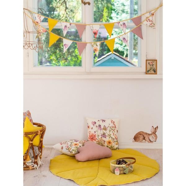 wildflower garland draped over a teepee tent for a functional and playful kids room setup