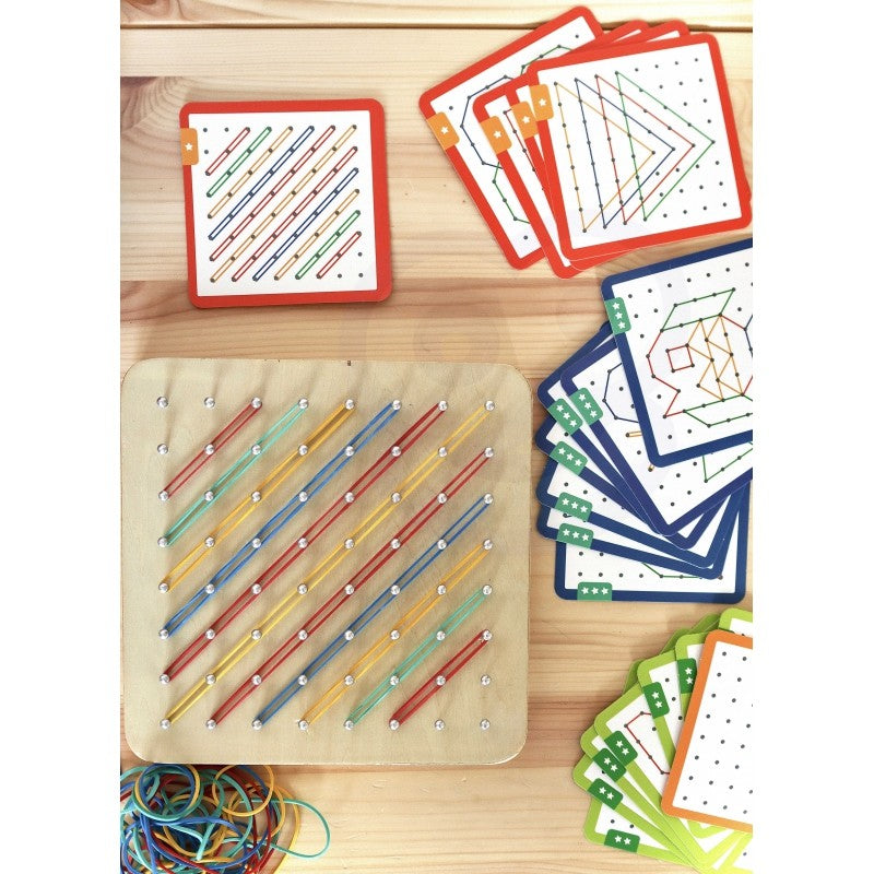 a child's hands creating a star shape with green rubber bands on the woopie geoplan wooden puzzle