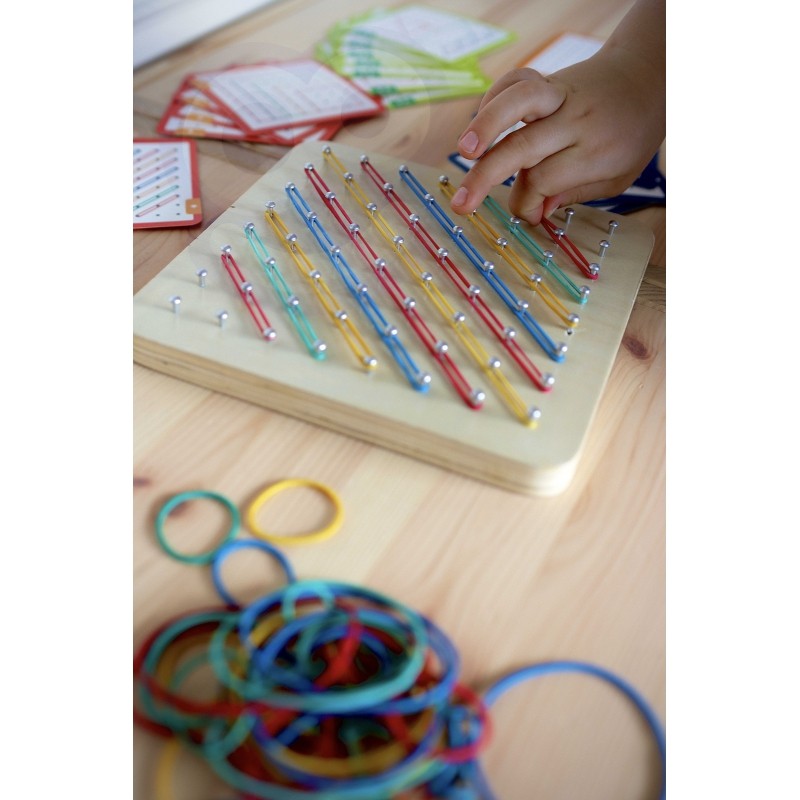 a child's hands gently creating a green star shape on the soft wooden geoplan puzzle board