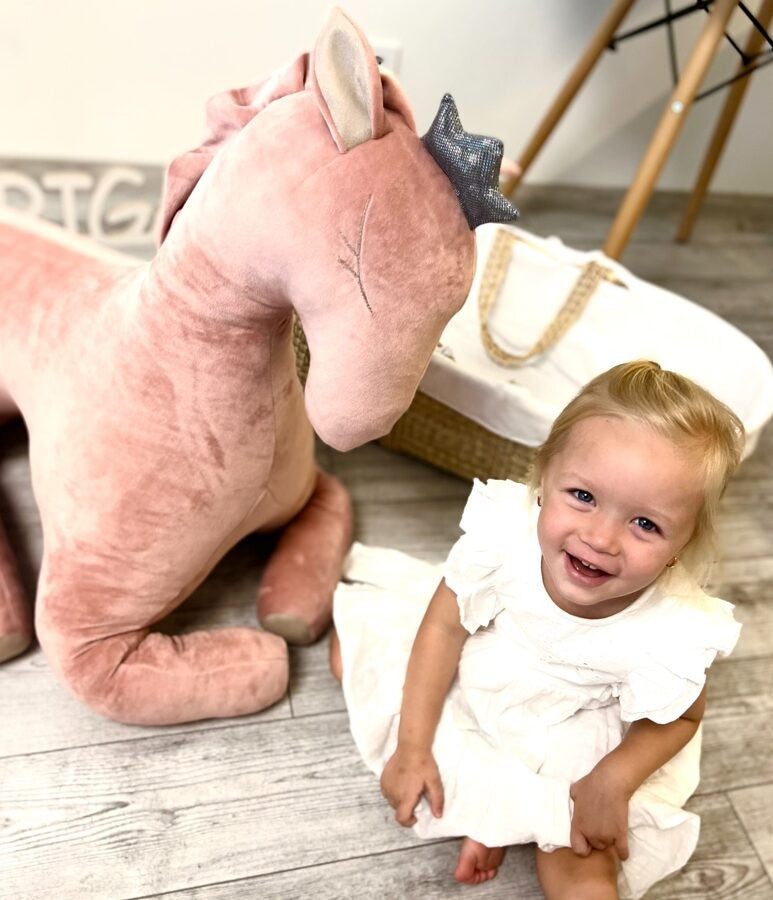 elegant dusty pink velvet peasus toy in soft, refined lighting