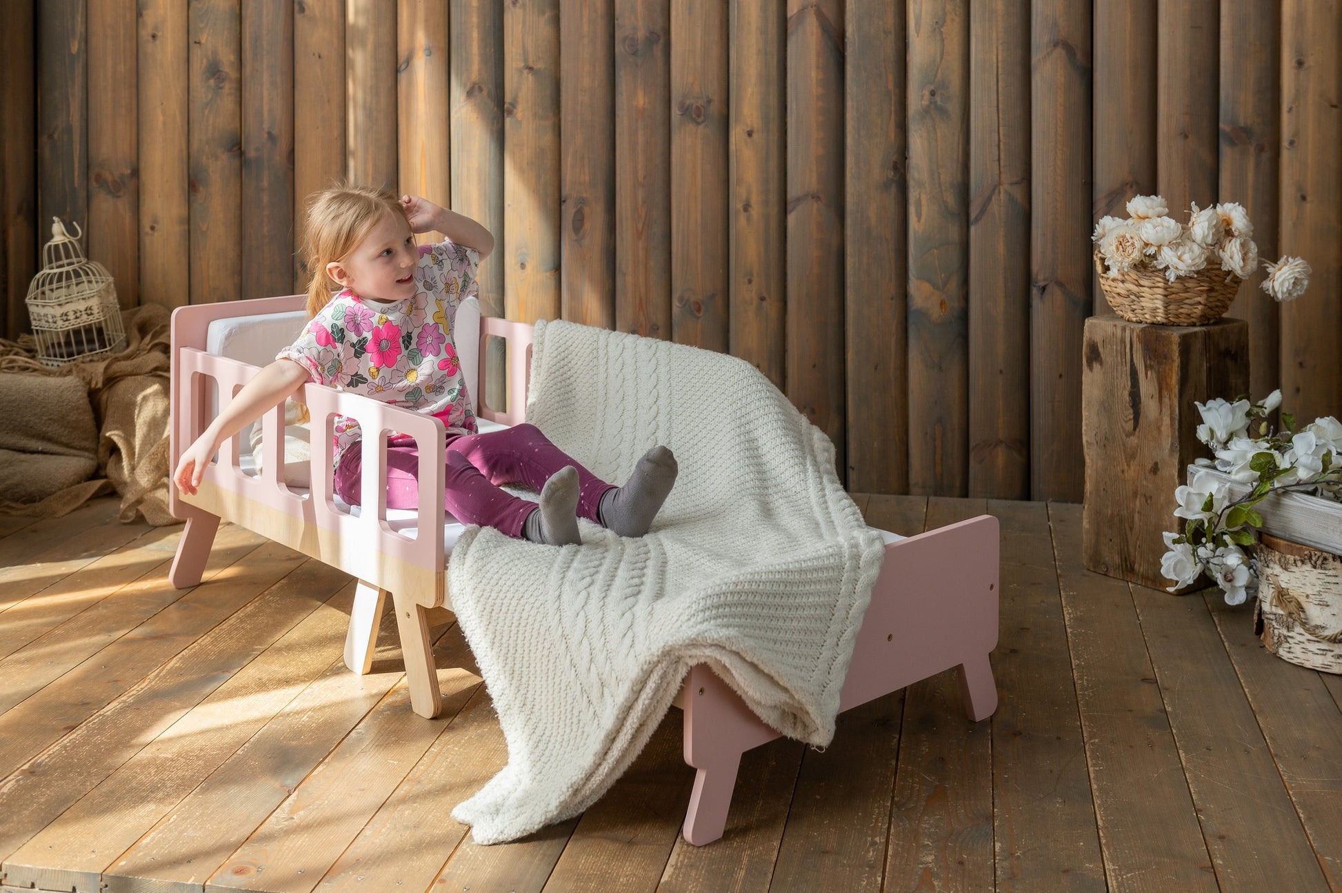 a playful kid transforming their growing bed into a sofa for daytime fun