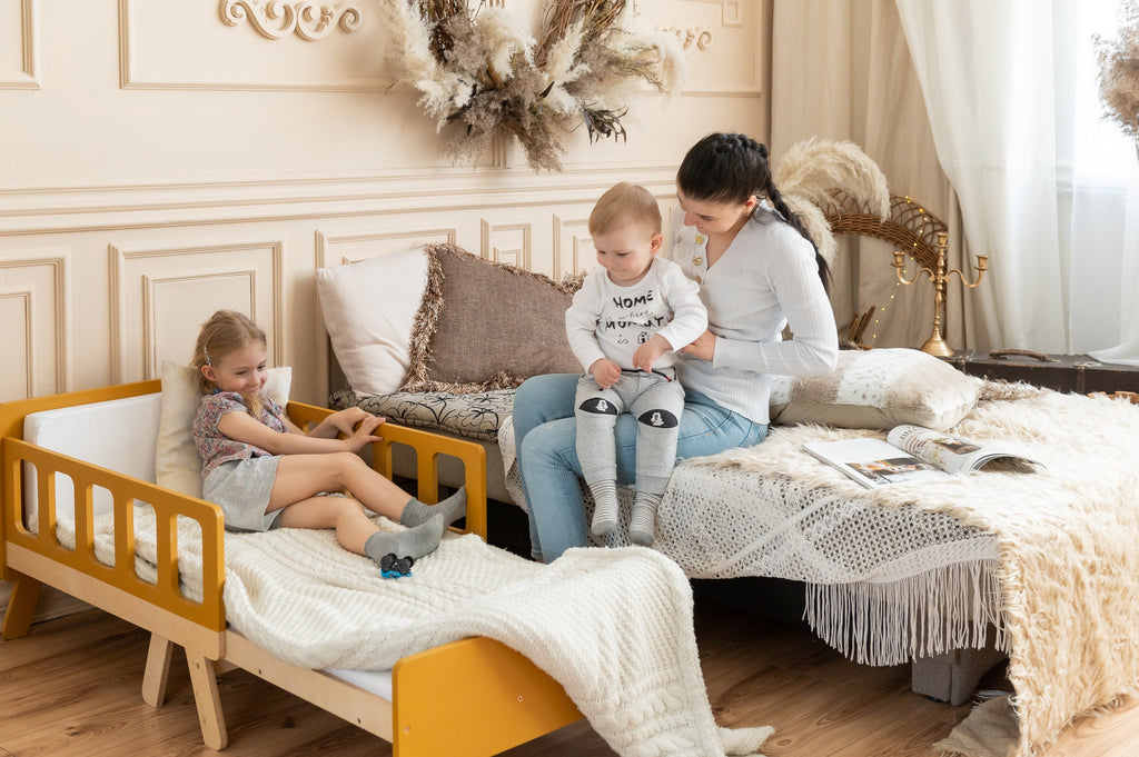 functional kids growing bed in a bright playroom with the mattress folded for daytime use