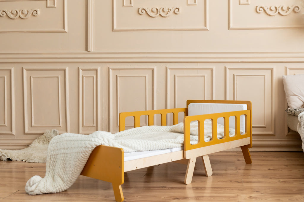 a child playing on the growing bed transformed into a cozy sofa with armrests