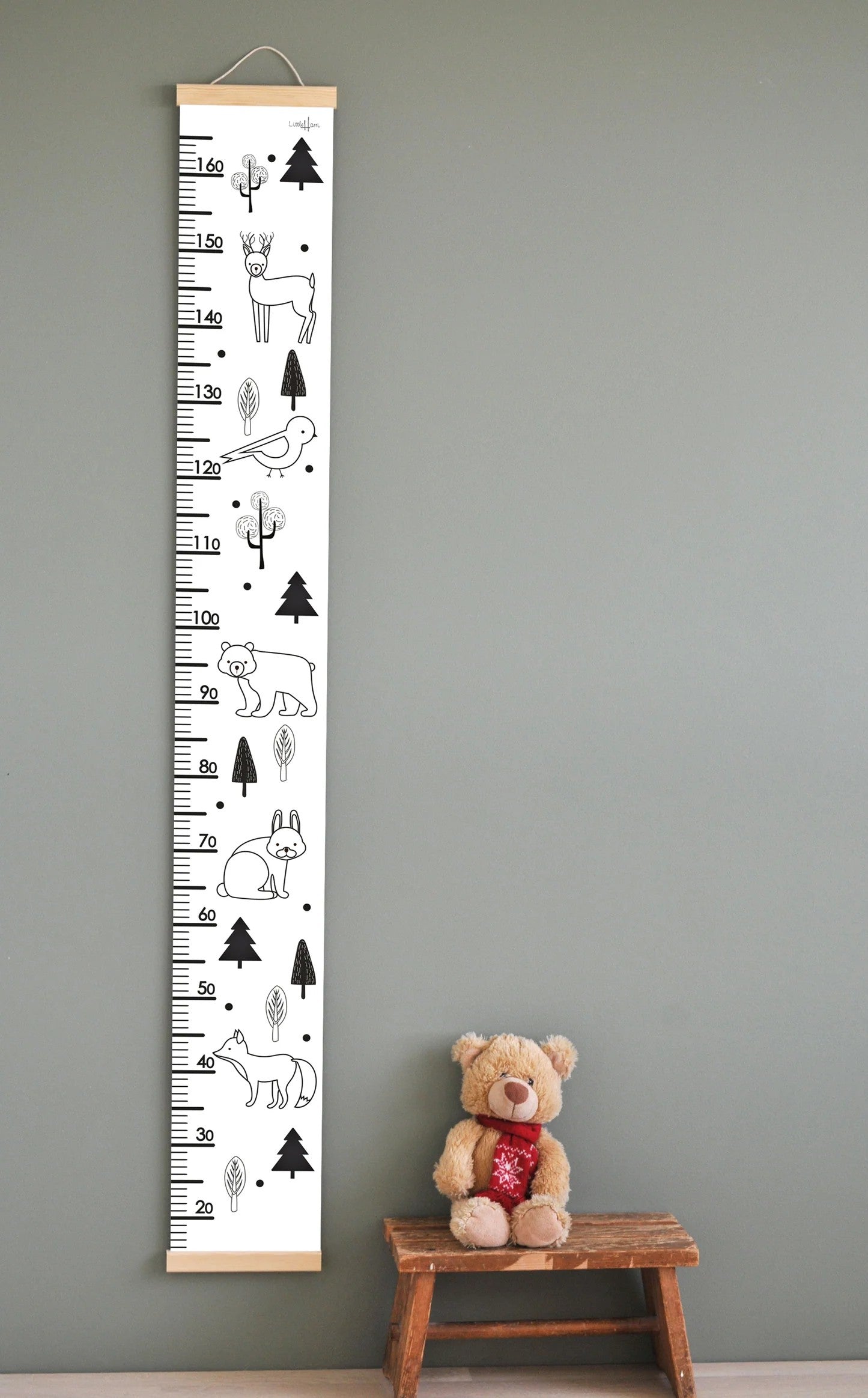 confident close-up of minimalist black and white animal growth chart on a modern nursery wall