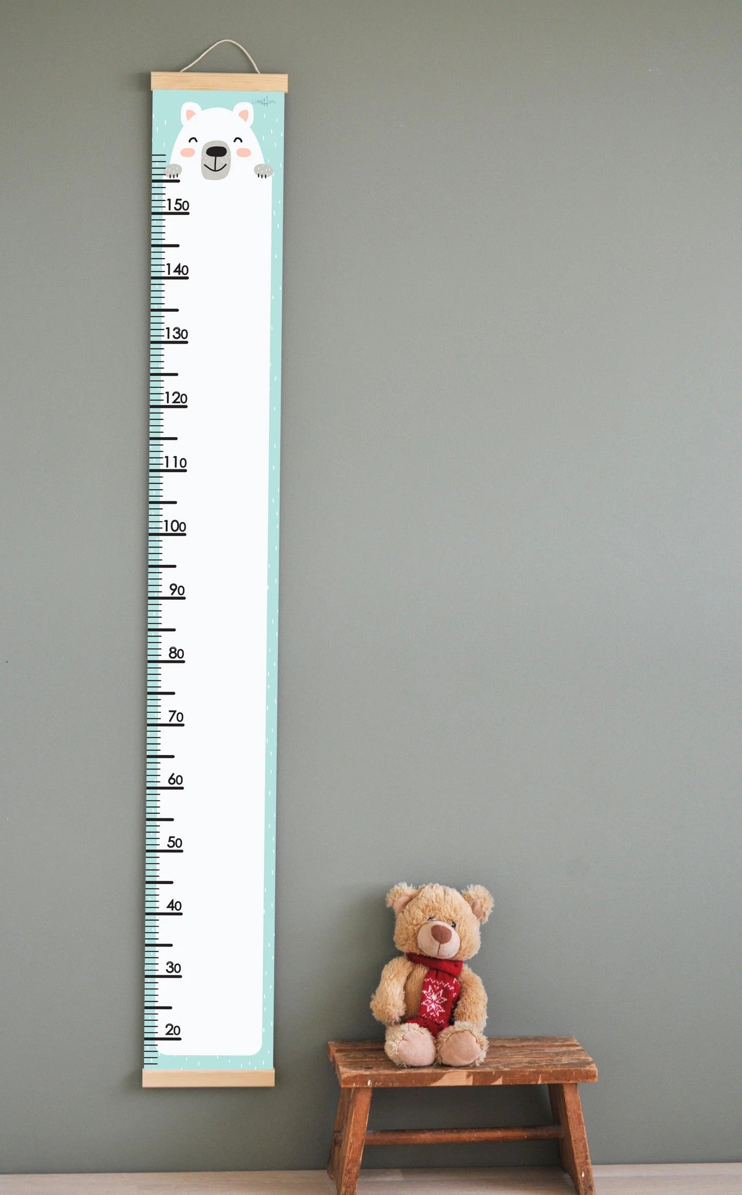 bold polar bear growth chart for kids mounted on a bright nursery wall