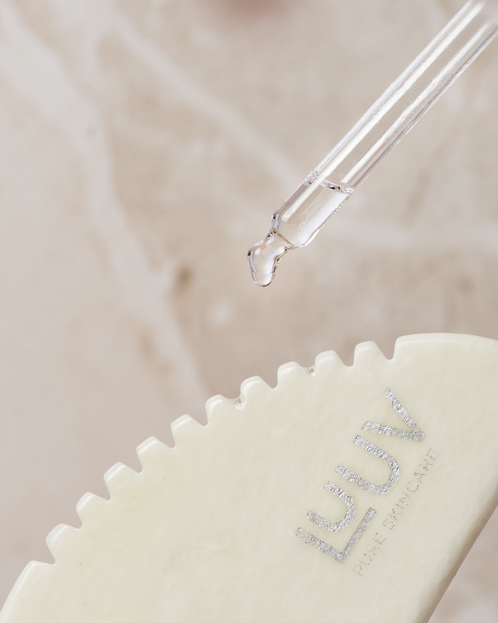 bold close-up of a handcrafted white jade gua sha tool on a dark background