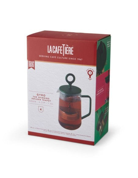 elegant green gyro teapot on a rustic wooden table with morning light highlighting its swirling infusion