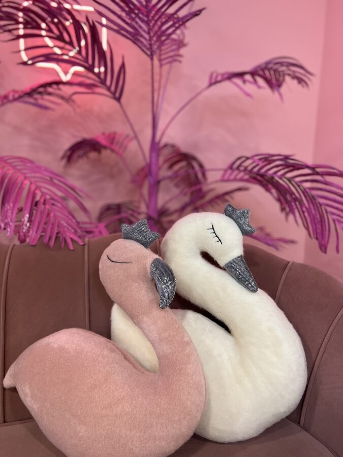 handmade pink flamingo soft toy crowned and confident in dramatic studio light