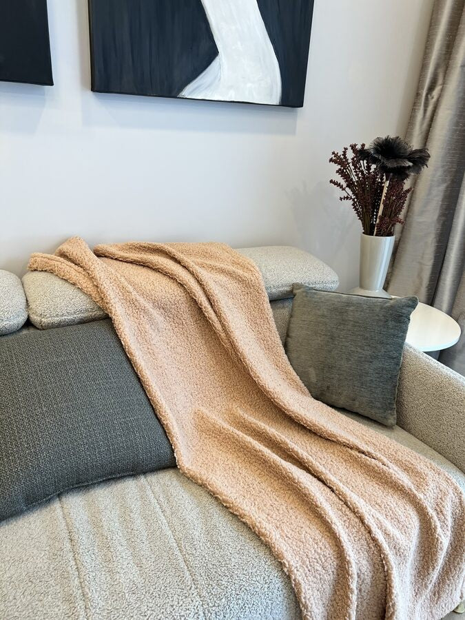a soft sand-colored teddy blanket draped gently over a child's bed for a quiet, comforting nap