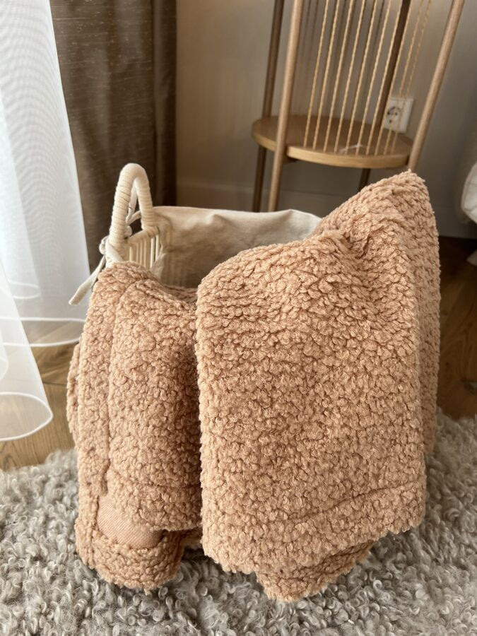 bold sand teddy blanket draped dramatically in warm morning light