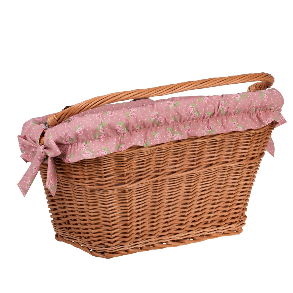 a child's teddy bear peeking from a willow bike basket with a soft fabric liner
