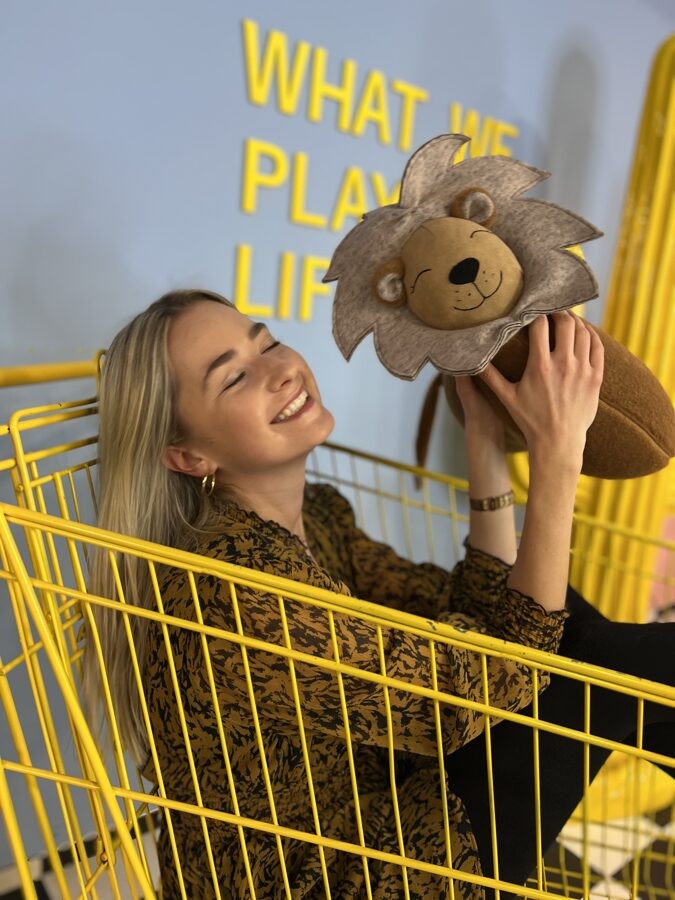 handmade lion cuddle pillow in warm nursery lighting, showcasing its soft llama wool and unique stitching