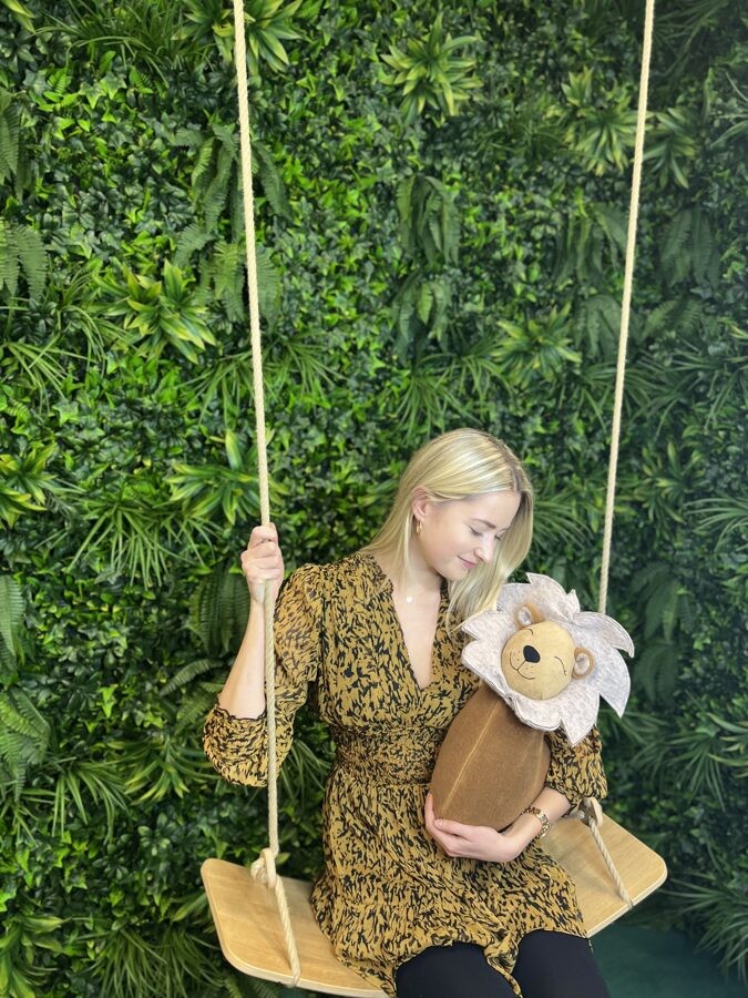 handmade lion cuddle pillow in a cozy nursery setting, glowing with soft morning light