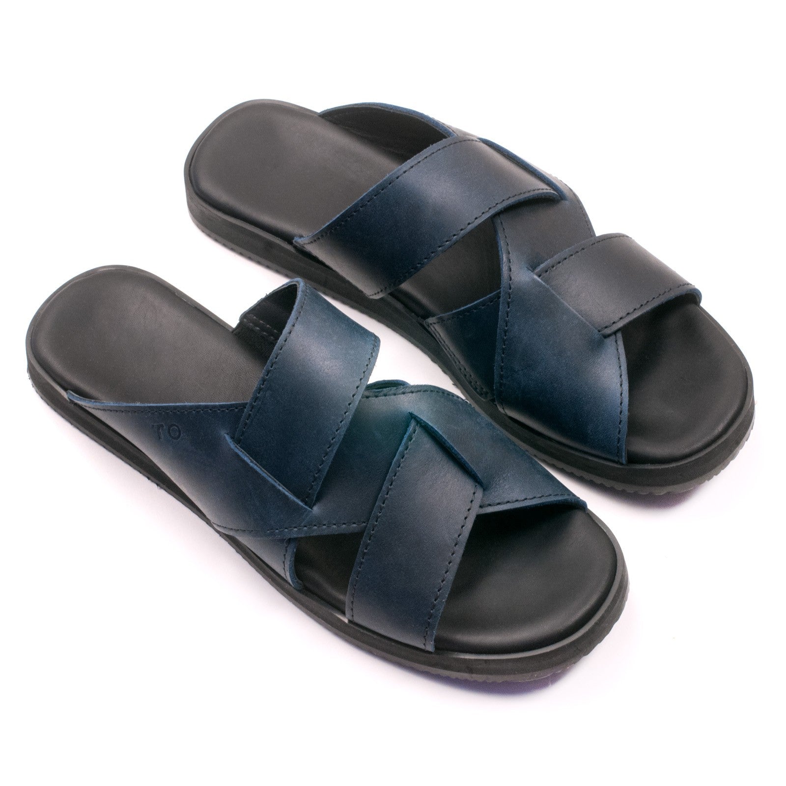 playful navy helsinki sandals for her with elastic side straps, shot in golden sunlight on a wooden deck